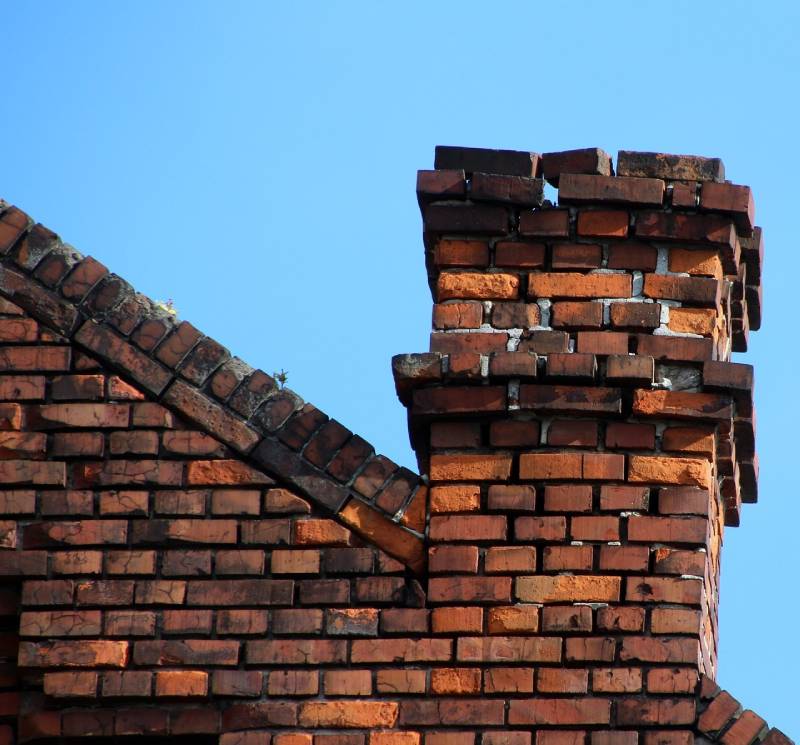 Signs Your Tewksbury Home Needs a Chimney Inspection Damaged chimney on an Tewksbury home showing cracks and missing mortar